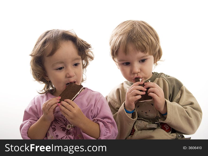 Twin sisters eating chocolate bars