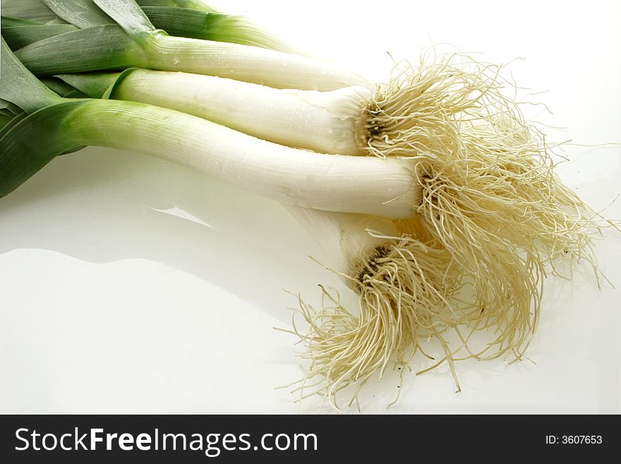 Roots of leeks on bright background