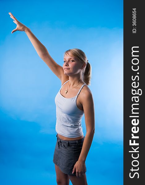 The girl in a white vest tries to reach the sky