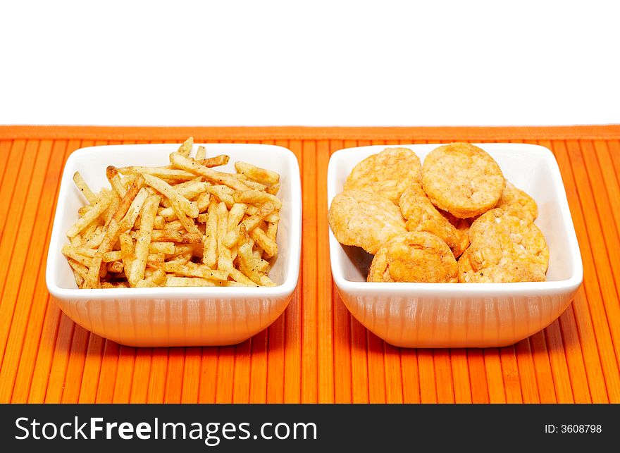 Two bowls with a variety of snacks on white background. Two bowls with a variety of snacks on white background