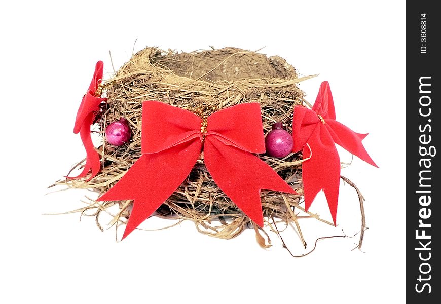 A bird nest that is decorated for christmas. A bird nest that is decorated for christmas