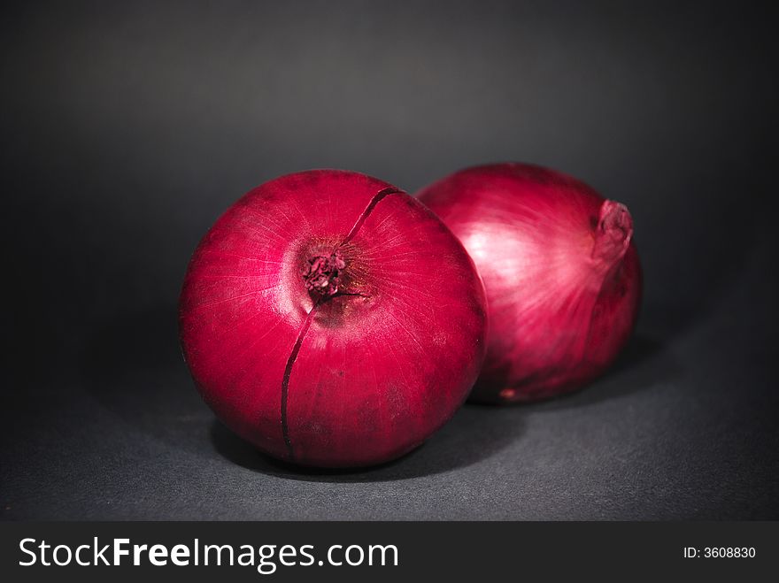 Two onions on black background