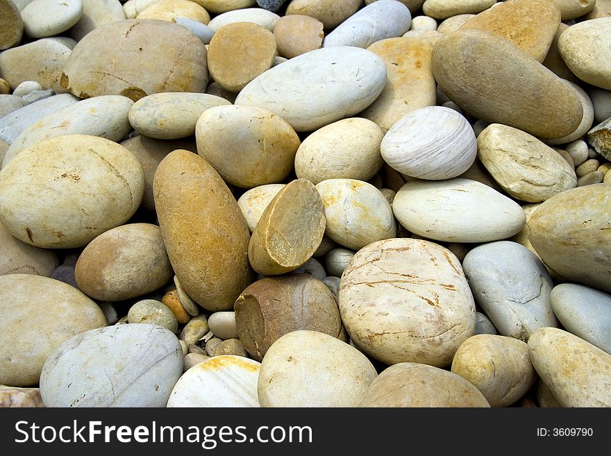 A lot of pebbles on a beach - background
