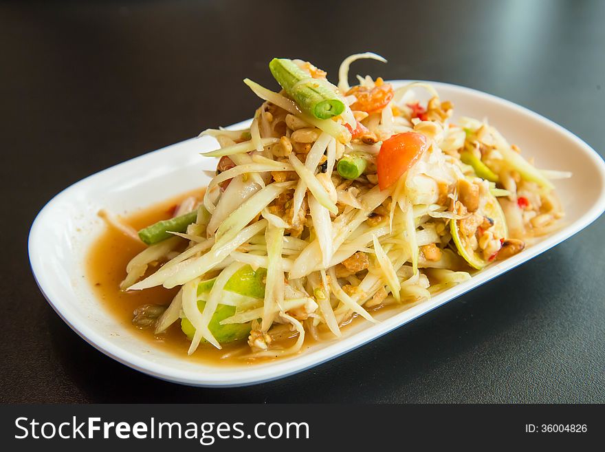 Green papaya salad on the table in the restaurant.