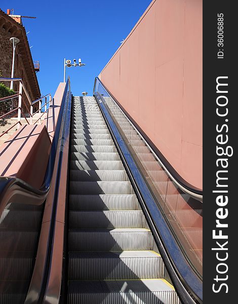 Moving staircase on street in city against blue sky. Moving staircase on street in city against blue sky