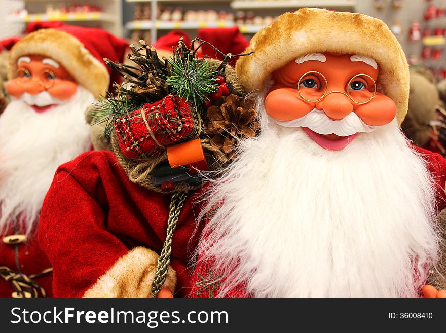 Santa Clauses smiling in a toy store.