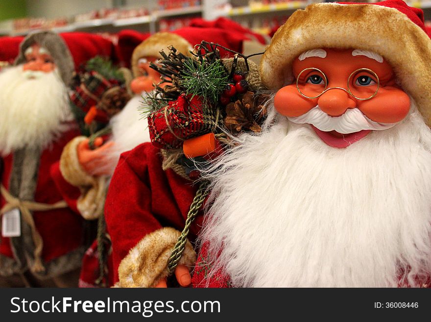 Santa Clauses smiling from toy store.