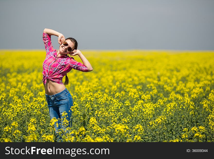 Close portrait of beautiful young woman on green grass in the summer outdoors. Close portrait of beautiful young woman on green grass in the summer outdoors