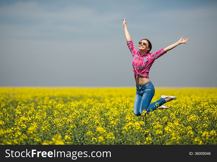 Young Beautiful Woman In Flowering Field In Summer. Outdoors