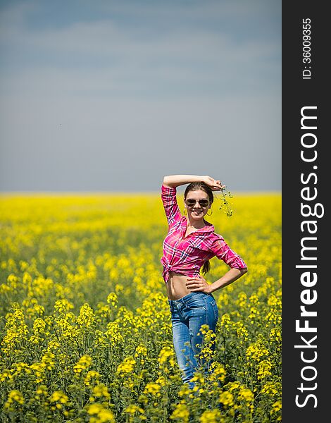 Young Beautiful Woman In Flowering Field In Summer. Outdoors