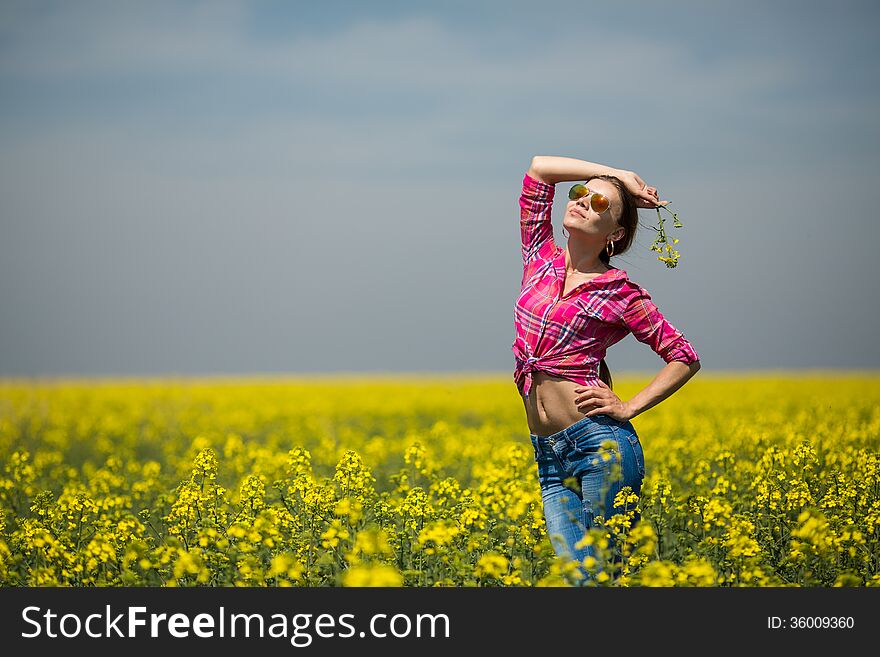 Close portrait of beautiful young woman on green grass in the summer outdoors. Close portrait of beautiful young woman on green grass in the summer outdoors