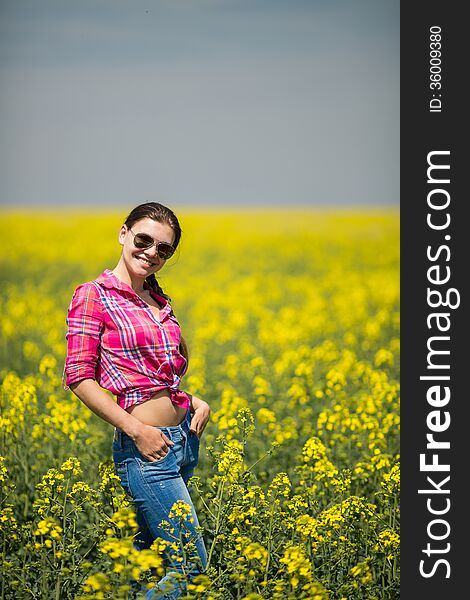 Young Beautiful Woman In Flowering Field In Summer. Outdoors