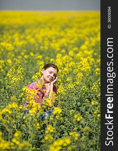 Close portrait of beautiful young woman on green grass in the summer outdoors. Close portrait of beautiful young woman on green grass in the summer outdoors