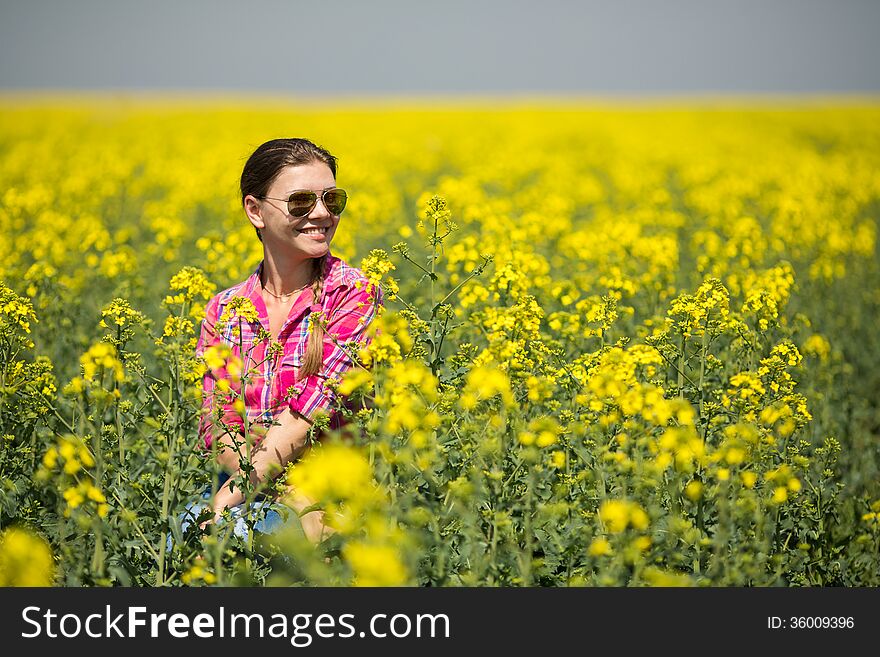 Young Beautiful Woman In Flowering Field In Summer. Outdoors