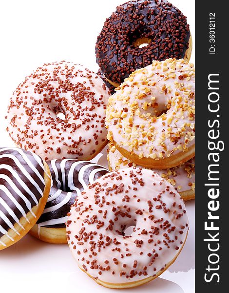 Donuts stuffed with chocolate, hazelnut, vanilla on white background