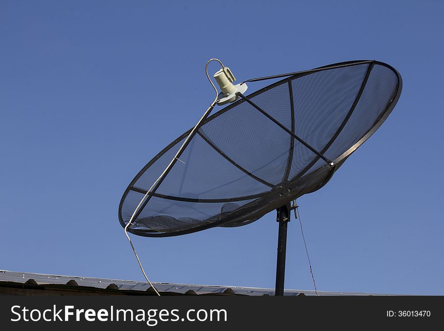 Defect black satellite dish under the blue sky