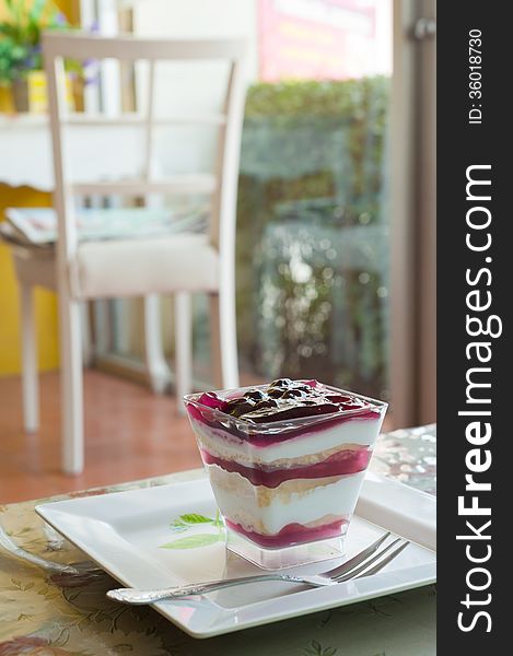 Fancy blueberry cake in white dish .