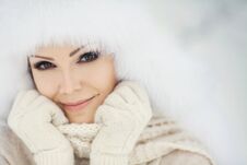 Winter Portrait Of Beautiful Smiling Woman With Snowflakes In White Furs Stock Photo Winter Portrait Of Beautiful Smiling Woman With Snowflakes In White Furs Stock Photo