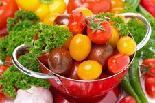 Assorted Cherry Tomatoes In A Colander, Garlic, Spices And Herbs Royalty Free Stock Images