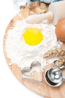 Baking Ingredients - Flour, Egg, Measuring Spoon And Baking Form Royalty Free Stock Image