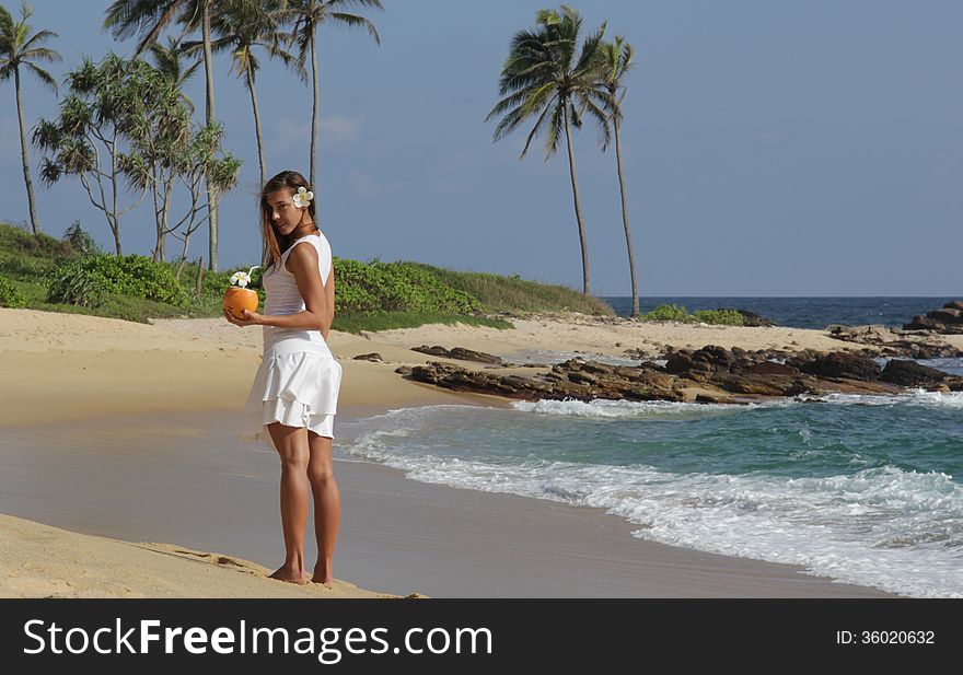 Young girl with coconut on the see side. Young girl with coconut on the see side