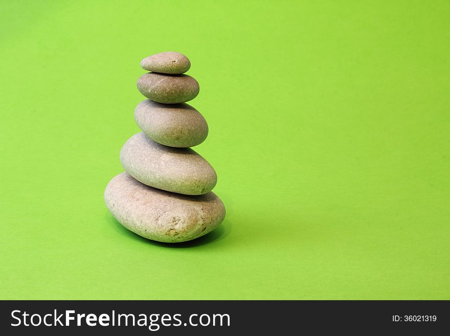 Pyramid of stones on a green background