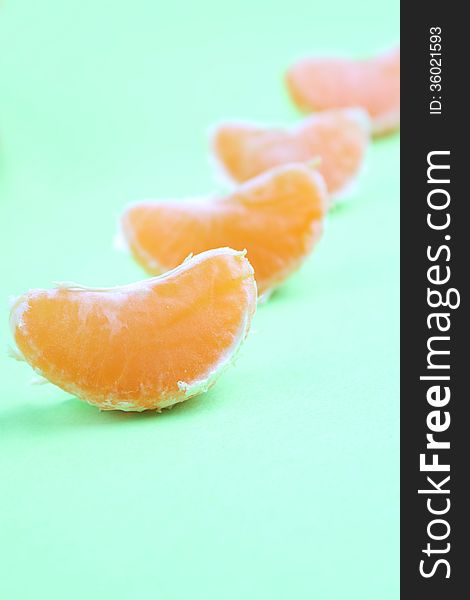 Peeled Orange On The Green Background