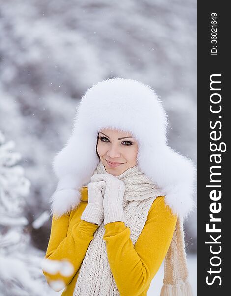 Winter Portrait Of Beautiful Smiling Woman With Snowflakes In White Furs