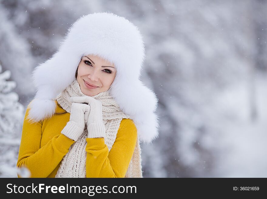 Beautiful winter portrait of young woman in the winter snowy scenery. Beautiful winter portrait of young woman in the winter snowy scenery