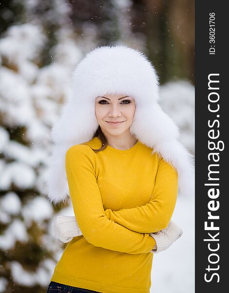Beautiful winter portrait of young woman in the winter snowy scenery. Beautiful winter portrait of young woman in the winter snowy scenery
