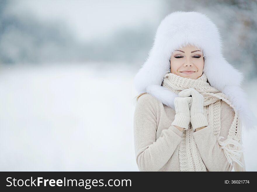 Beautiful winter portrait of young woman in the winter snowy scenery. Beautiful winter portrait of young woman in the winter snowy scenery