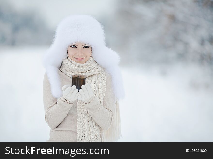 Beautiful winter portrait of young woman in the winter snowy scenery. Beautiful winter portrait of young woman in the winter snowy scenery