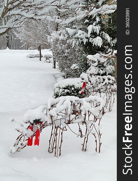 Christmas reindeer outdoor lawn decorations covered in snow after a winter storm. Christmas reindeer outdoor lawn decorations covered in snow after a winter storm.