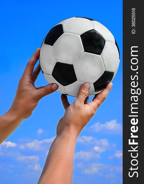 Football, soccer ball in man hand on blue sky. Football, soccer ball in man hand on blue sky