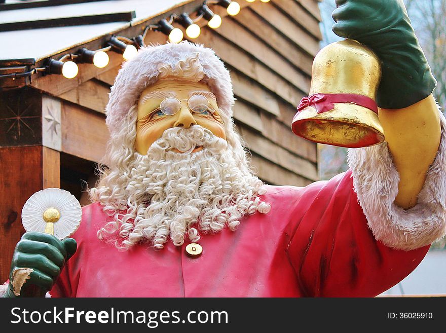 Statue of santa claus dressed in red with beard and hat