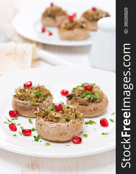 Appetizer - stuffed mushrooms with herbs and pomegranate seeds, vertical