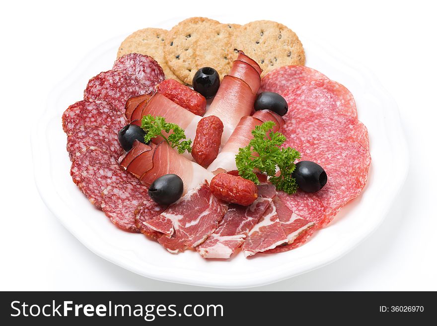 Assorted deli meats on a plate, isolated on white
