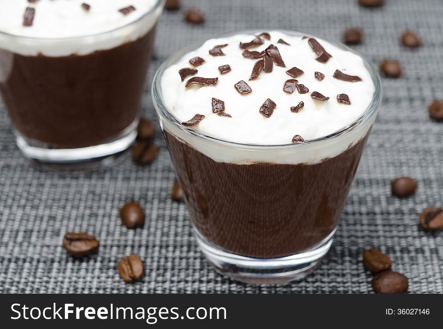 Coffee and chocolate mousse with whipped cream, horizontal close-up