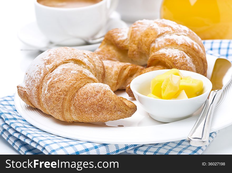 Croissants with butter, espresso and orange juice for breakfast, close-up, horizontal