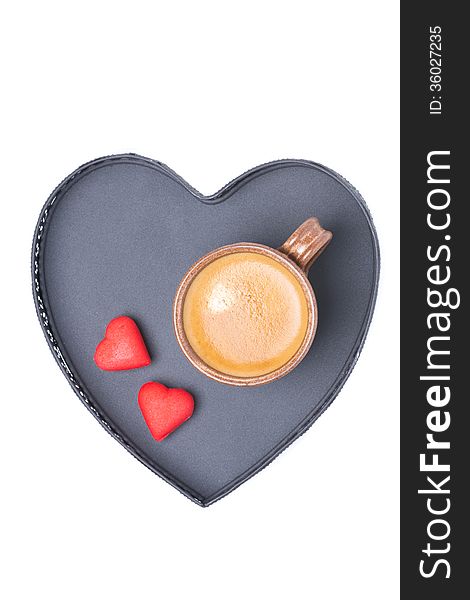 Espresso cup and candy on a tray in the form of heart, isolated on white