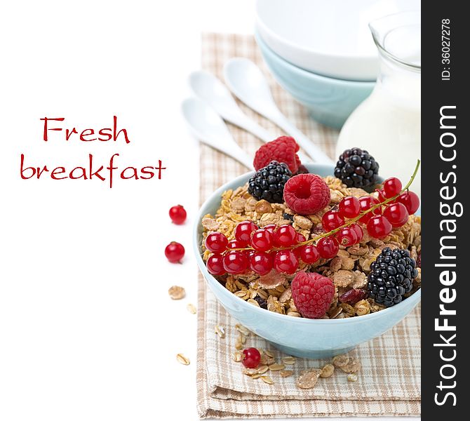 Homemade granola with fresh berries and jug of milk, isolated