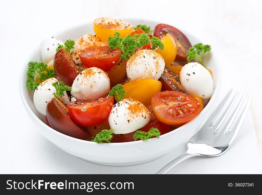 Salad with mozzarella and colorful cherry tomatoes, close-up