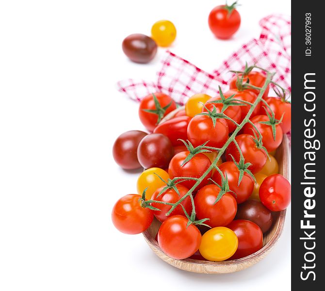 Assorted cherry tomatoes in wooden bowl, isolated on white