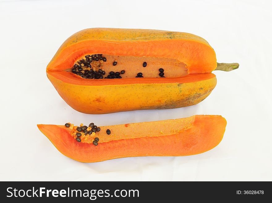 Papaya sliced isolated and cut into pieces on white background