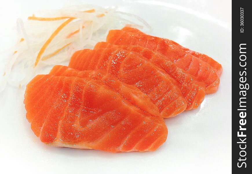 Salmon Sashimi slide placed on the plate.