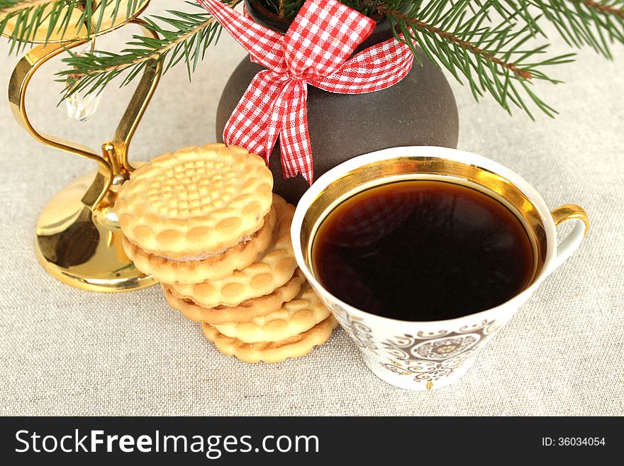 Cup of coffee and a bouquet with Christmas cookies