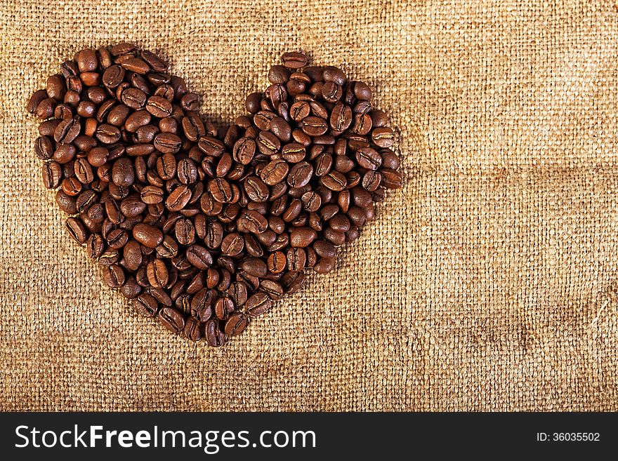 Background in the form of heart from fried coffee beans