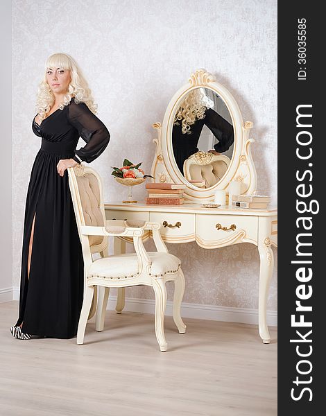Pretty blonde woman in a luxury bedroom