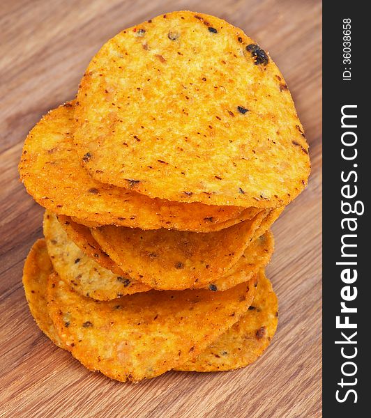 Stack of Homemade Potato Chips closeup on Wooden background