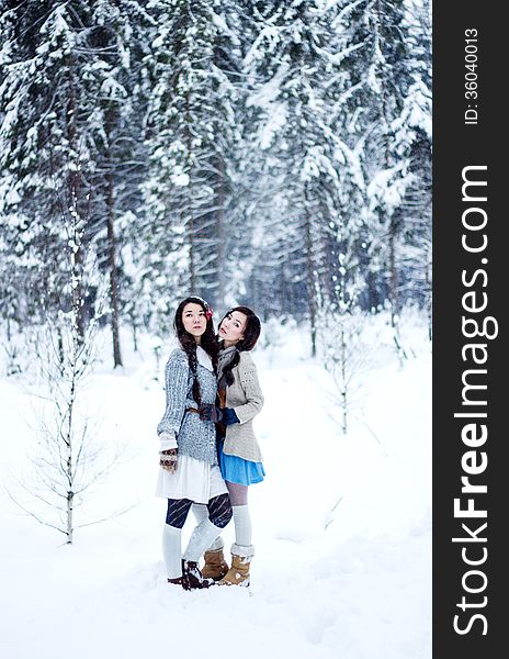 Fashion Women In Warm Sweaters On White Snow Forest Background